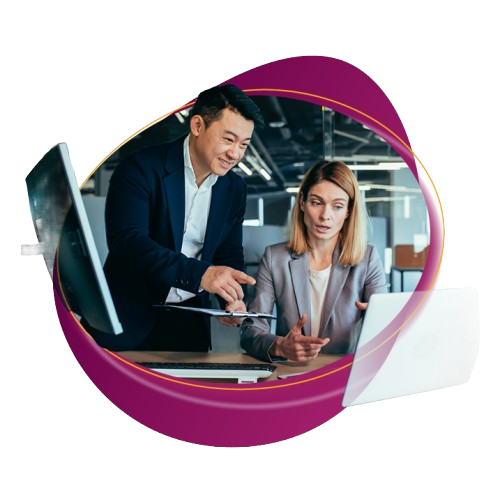 two coworkers smiling pointing a computer