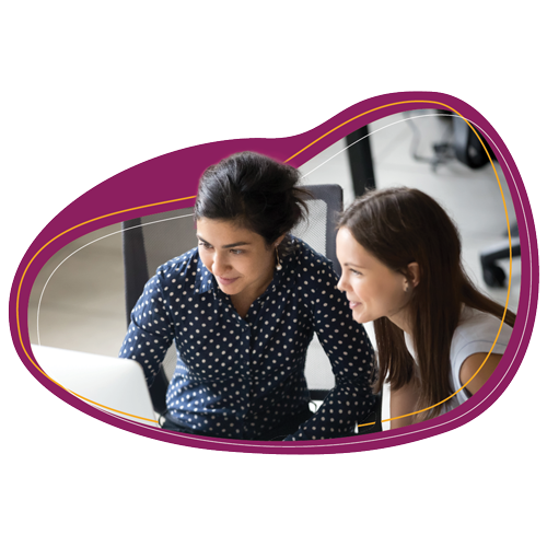 Two people gathered around a table, looking at something together