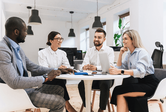 Professionals collaborating around a table during a meeting in a modern office.