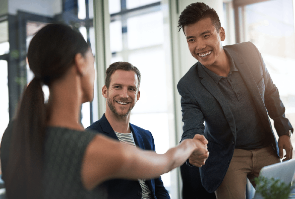 Professionals greeting each other with a handshake during a workplace meeting
