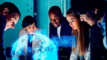 Group of professionals discussing global data projections on a digital interface.