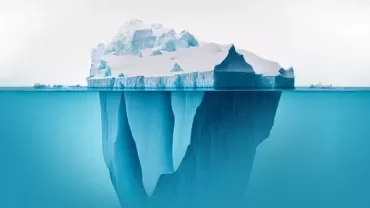 Large iceberg above and below ocean surface.