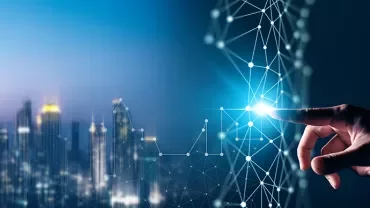 Hand touching digital interface with city skyline in background.