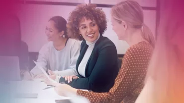 Group of people engaged in a meeting at a table.