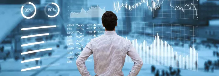 Person analyzing financial charts on a digital screen over a busy city backdrop.