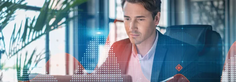 Person working on a computer with data graphics overlay.