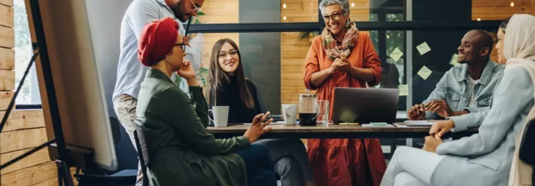 Group of people having a discussion in a modern office setting.