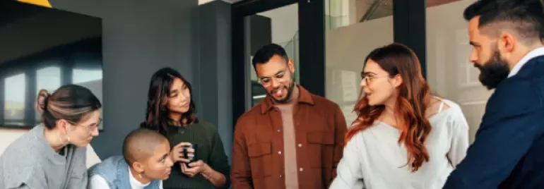 Group of people gathered for a discussion in an office setting.